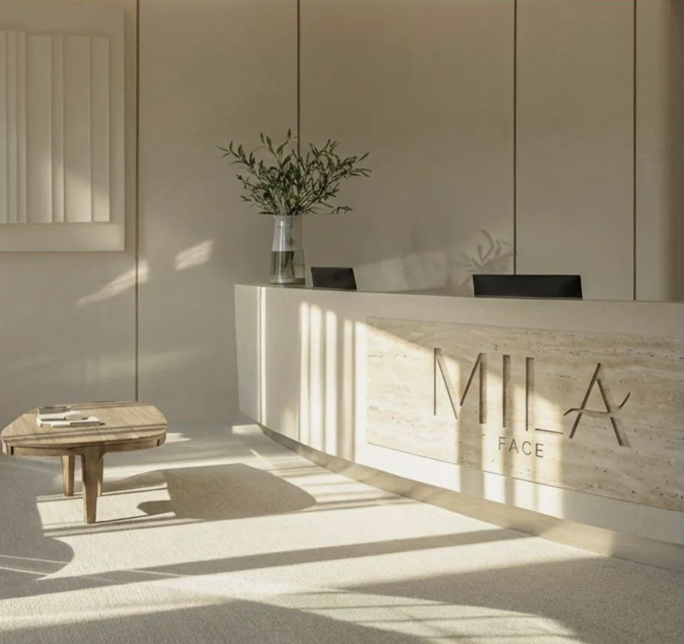 MILA FACE reception area with curved stone desk and warm natural light