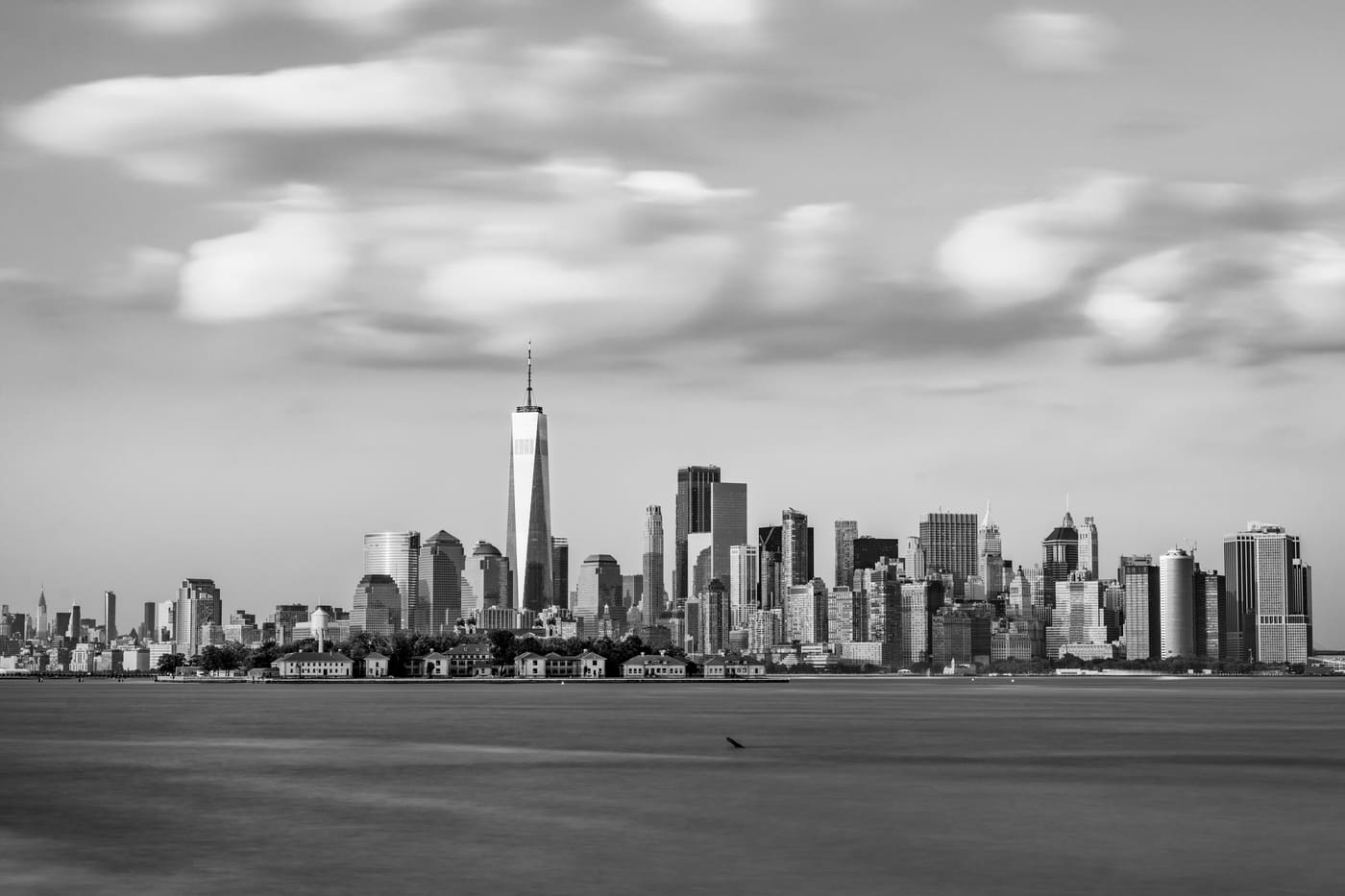 Black-and-white view of the Lower Manhattan skyline across the water